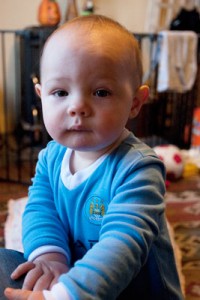 Boy in a Manchester City sleepsuit