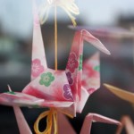 An origami bird decorating a shop window in Carndonagh