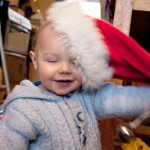 A boy pulling off a Santa hat